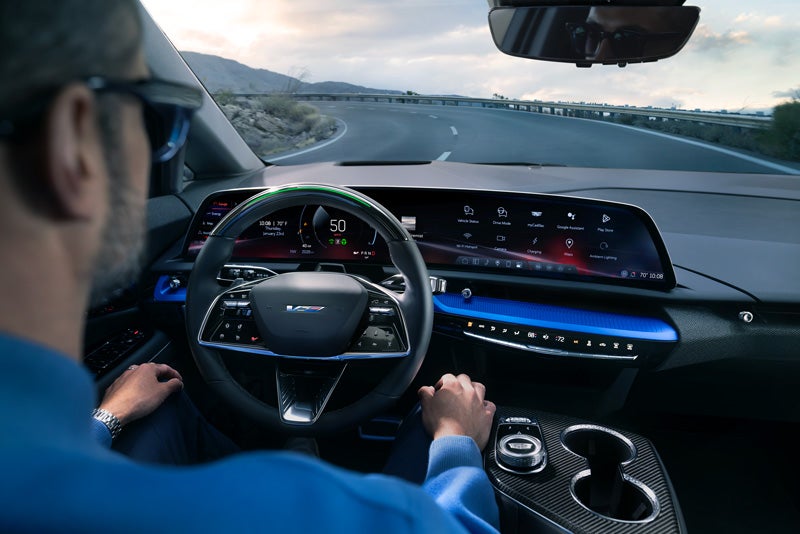 Front View of the 2026 OPTIQ-V Driving Through the Dusk Utilizing its Headlights | Jerry's Cadillac in Weatherford TX